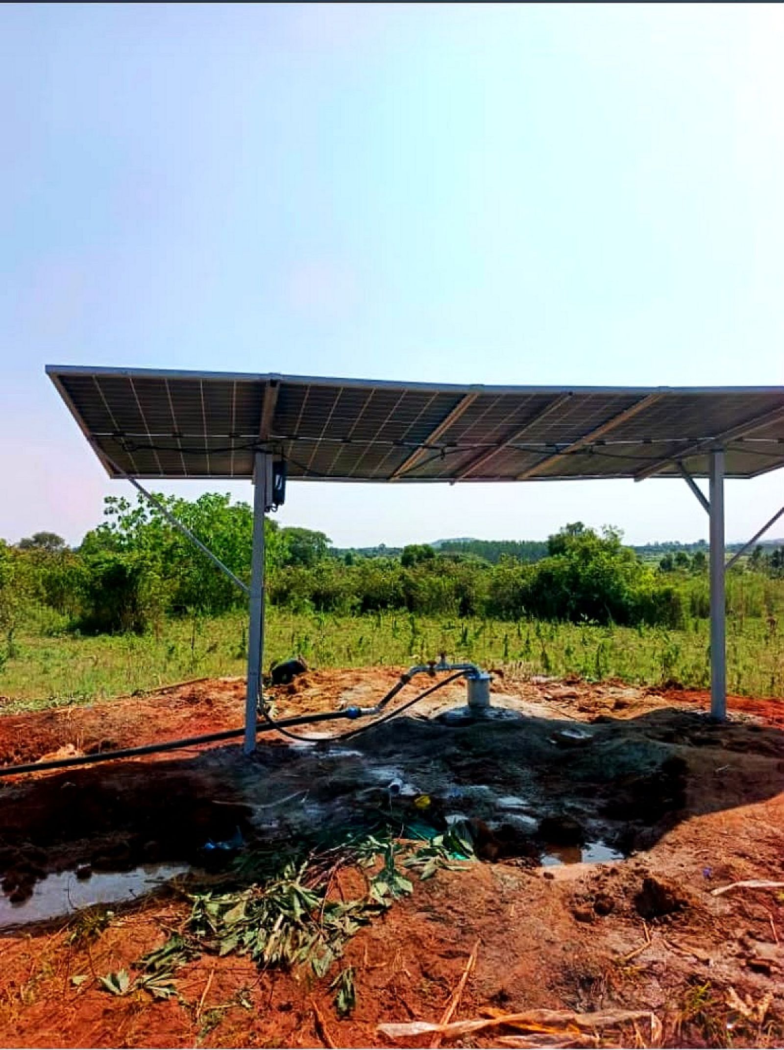 Solar panels on a steel frame standing over a borehole