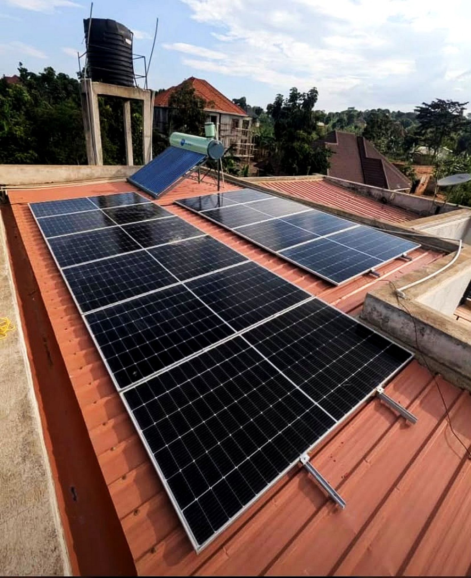 Solar panels and a solar water heater on a Kampala rooftop