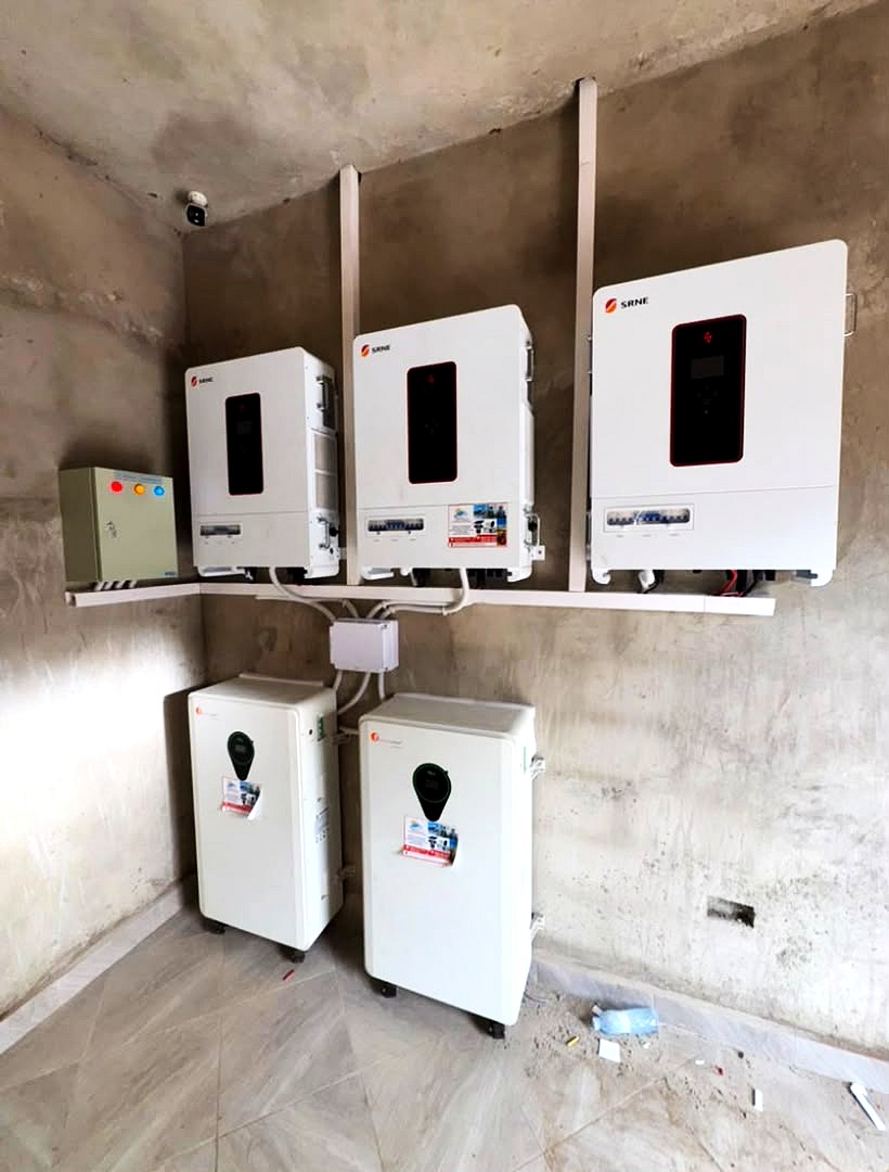 Three SRNE inverters and two lithium batteries installed on a wall